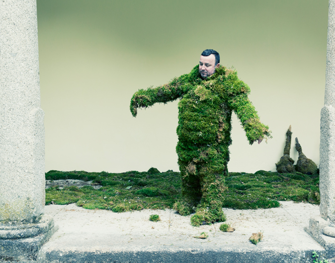 Man trying to walk in a suit of moss. The Moss Men of Bejar.