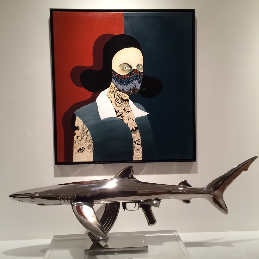 Rune Christensen painting above a Christopher Schulz shark-machine gun sculpture, Photo: Art Report