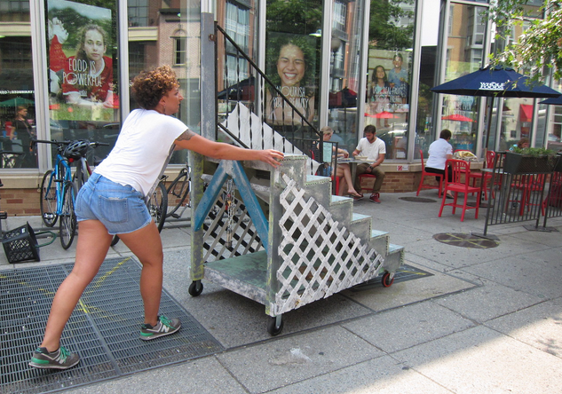 Women pushing moveable stoop 